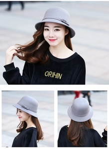 Dettaglio di un cappello cloche in lana grigia da donna con fiocco laterale e cupola tonda