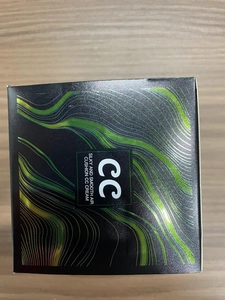 Macro shot of the black and green CC cream packaging box showing product texture details