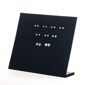 L-shaped black velvet earring display stand showcasing various pearl and floral studs