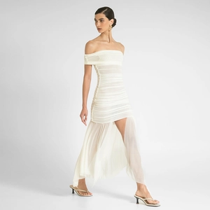 Detailed view of white strapless mini dress featuring pleated texture and airy tulle train
