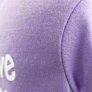 Close-up of lilac pet hoodie fabric showing soft knit texture and durable stitching