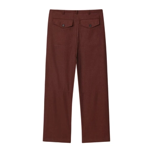 Detail view of brown casual trousers featuring rear buttoned flap pockets and cotton texture