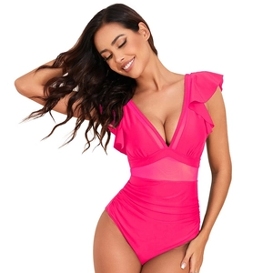 Close-up of hot pink one-piece swimsuit featuring mesh panels and ruffled V-neck details