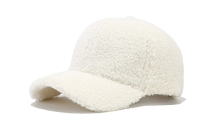 Detail shot of the plush lamb wool texture on the white winter baseball cap