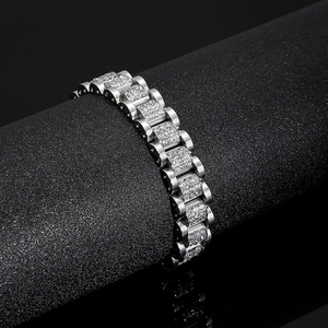 Men's silver stainless steel bracelet with CNC set crystals on a black display stand