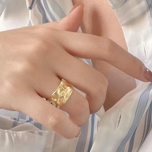 French retro style wide gold ring with irregular wavy texture on model's hand