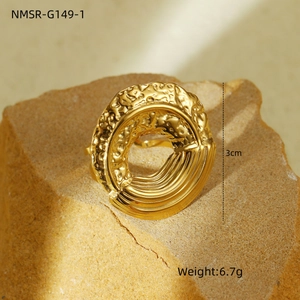 Detail of 3cm golden stainless steel ring with hammered and linear textures