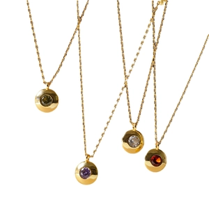 Detailed close-up of colorful round zircon pendants with 18K gold plated chains on white background