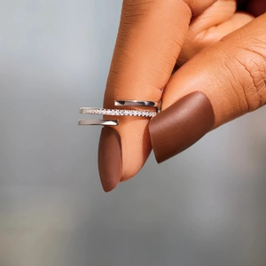 Macro shot of silver S925 multi-layered crisscross ring with white zircons on hand