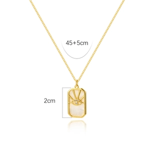 Detailed view of golden evil eye pendant with mother of pearl and size markings