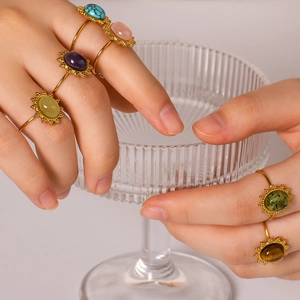 Vintage stainless steel sunburst rings with colorful natural stones on fingers