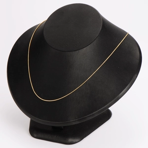 1mm minimalist 18K gold-plated stainless steel snake chain necklace on a black mannequin