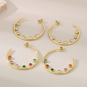 Detail of C-shaped gold stainless steel earrings with colorful and white zircon stones