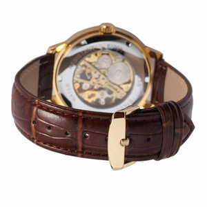 Detail view of the transparent case back showing golden mechanical movement and brown leather strap