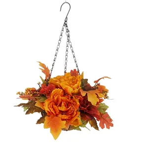 Autumn hanging flower basket with red peonies, maple leaves, and berries for garden decor
