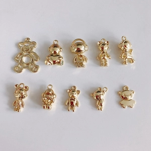 Macro view of ten assorted gold bear pendants for DIY jewelry and crafts making
