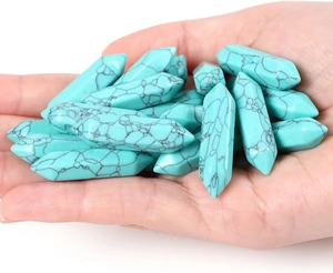 Macro view of double-pointed hexagonal crystal pendants with natural turquoise texture