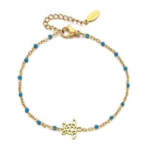 Detailed macro view of a gold stainless steel turtle charm bracelet with blue beads