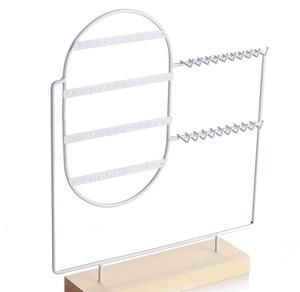 White metal jewelry display rack with wooden base featuring earring holes and necklace hooks