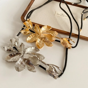 Detail of metallic tulip pendant with brushed texture and adjustable black cord