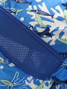 Close-up of ocean-themed fabric with breathable blue mesh and white coral patterns