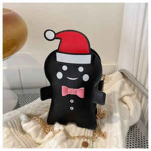 Detailed view of gingerbread man crossbody bag on knit sweater for Christmas gift ideas