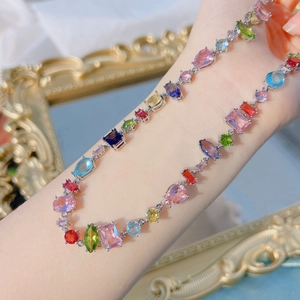Close-up of rainbow crystal bracelet with multi-colored gemstones on silver metal base