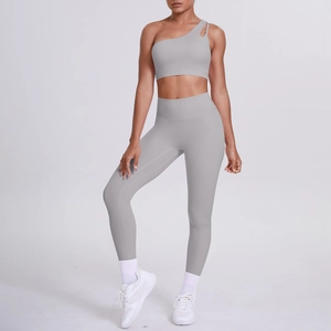 Detail of light grey one-shoulder sports bra and high-waist leggings yoga set