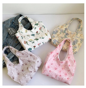 Flat lay of four lightweight floral tote bags in various artistic patterns and colors