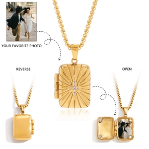 Macro view of gold tarot locket necklace showing front, reverse, and photo slot detail