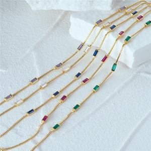 Macro shot of 925 silver gold-plated bracelet with multi-colored baguette-cut crystals