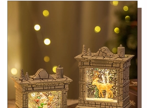 Close-up detail of retro fireplace snow globe with shimmering glitter and warm Christmas lights
