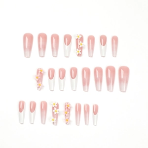 Pink gradient French tip press-on nails with 3D white floral accents and coffin shape