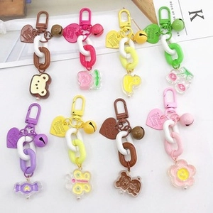 Detailed view of colorful cartoon bag charms with plastic chains and metal lobster clasps