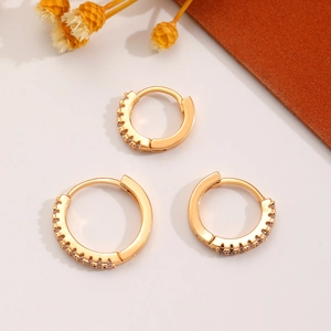 Detailed view of three gold-plated hoop earrings set with sparkling cubic zirconia stones