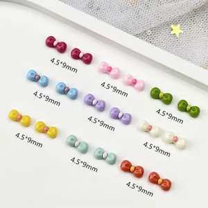 Colorful resin bow nail art charms in nine shades, size 4.5x9mm for DIY decoration