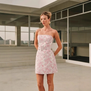 Detail of pink floral jacquard fabric on strapless dress with matching square buckle belt