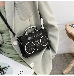 Detailed close-up of a vintage radio-shaped crossbody bag featuring textured knobs and dial