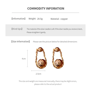 Detailed view of golden irregular round earrings showing dimensions of 4cm by 2.5cm