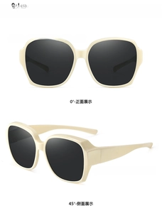 Close-up of oversized cream frames and gray lenses on these polarized fit-over sunglasses