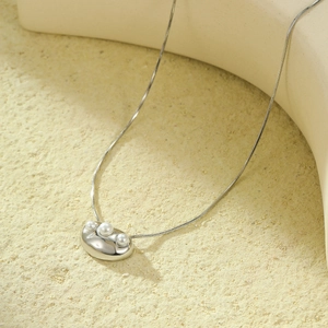 Elegant silver snake chain necklace featuring a pebble pendant with three white pearls