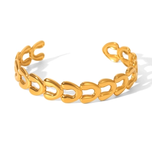 Close-up of 18k gold plated open bangle with hollow chain design and polished finish