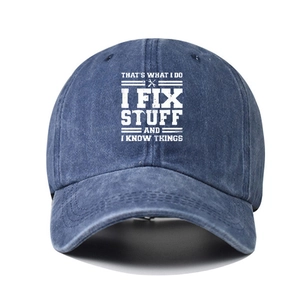 Detailed view of dark blue washed denim baseball cap with vintage white printed slogan