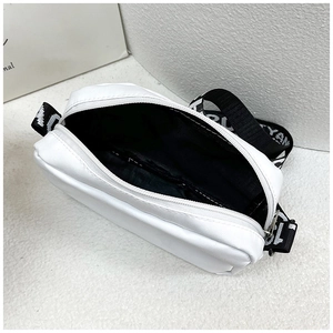 Top view of white nylon crossbody bag showing the zipper opening and black inner lining