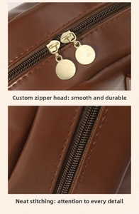 Detail of premium brown leather pouch showing smooth gold metal zippers and neat stitching