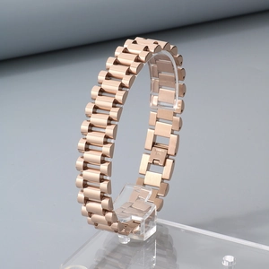 Close-up of rose gold stainless steel watch band bracelet on a transparent stand