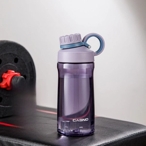 Close-up of a 500ml purple sports water bottle with tea infuser on gym equipment