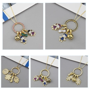 Detail of colorful cubic zirconia charms on gold plated necklaces with diverse symbols