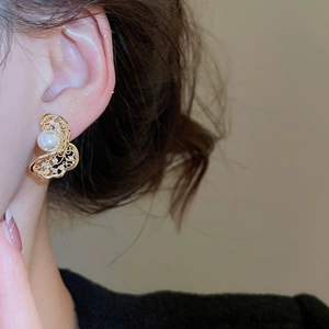 Detailed view of hollow butterfly pearl earrings with gold plating and zircon accents