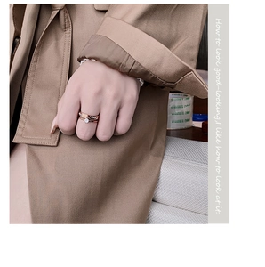 Close-up of a rose gold double-layered titanium ring with large zircon stone on finger